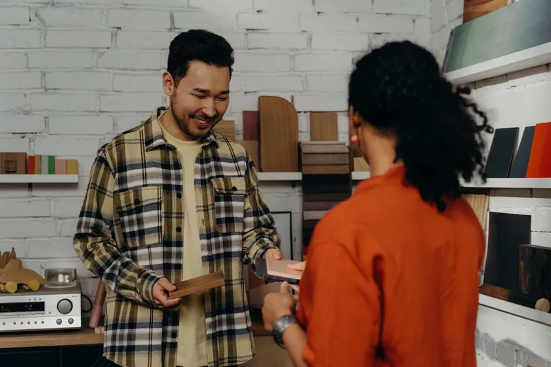 A shopkeeper taking payment from a customer
